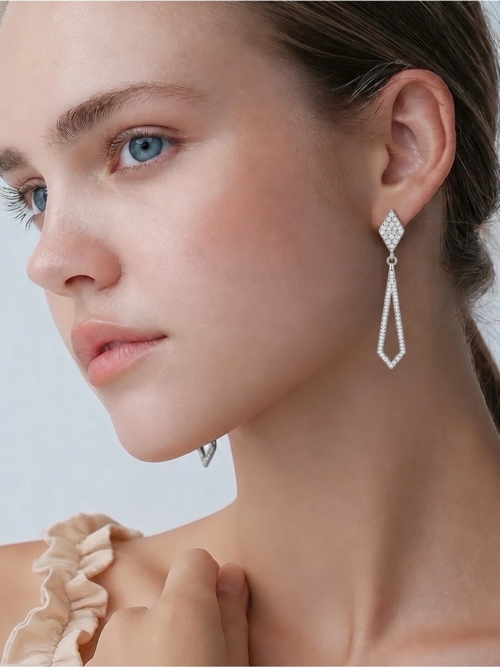 Moissanite drop earrings set in rhodium over 925 Sterling Silver.